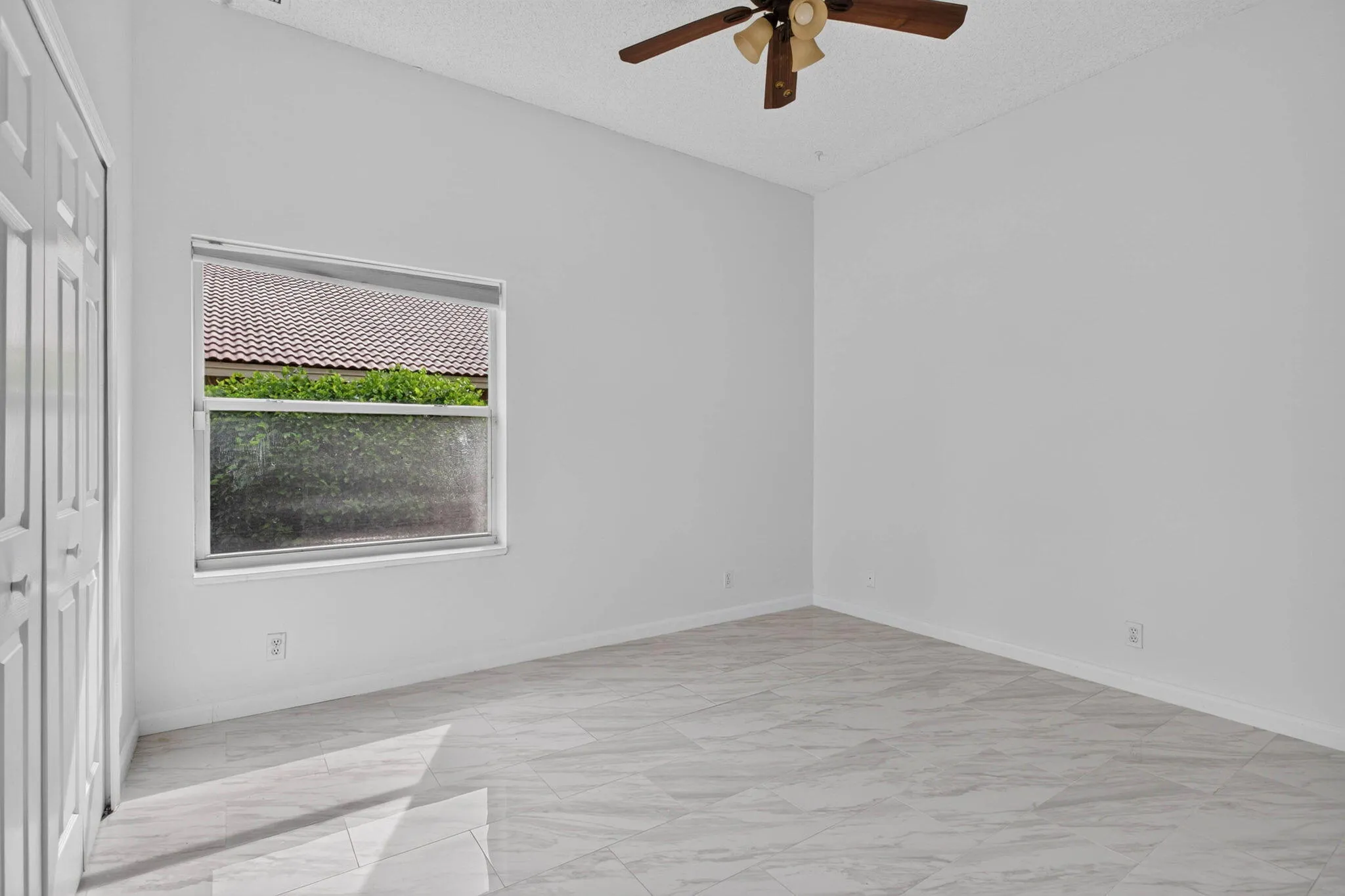 Third bedroom. View looking from entry door towards window.