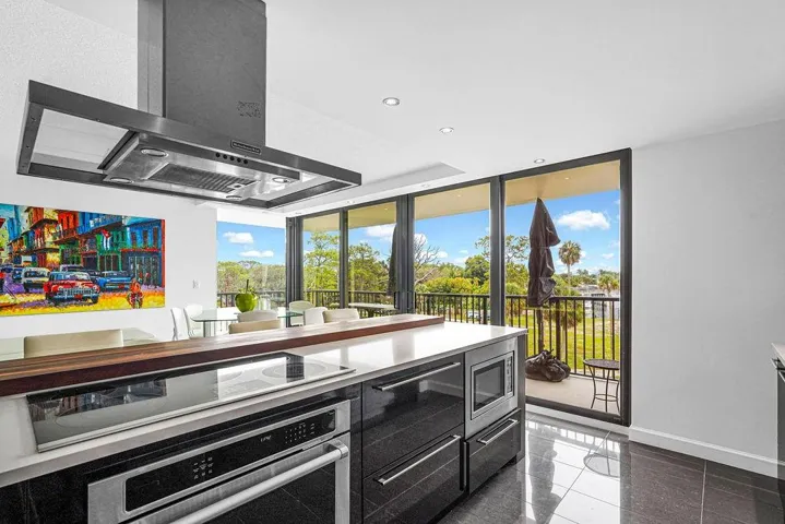 Kitchen with SS cooktop, undercounter oven, microwave & hood
