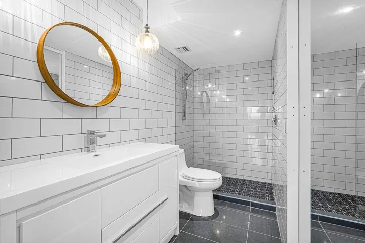 Chic white tile bathroom with step-in glass enclosed shower