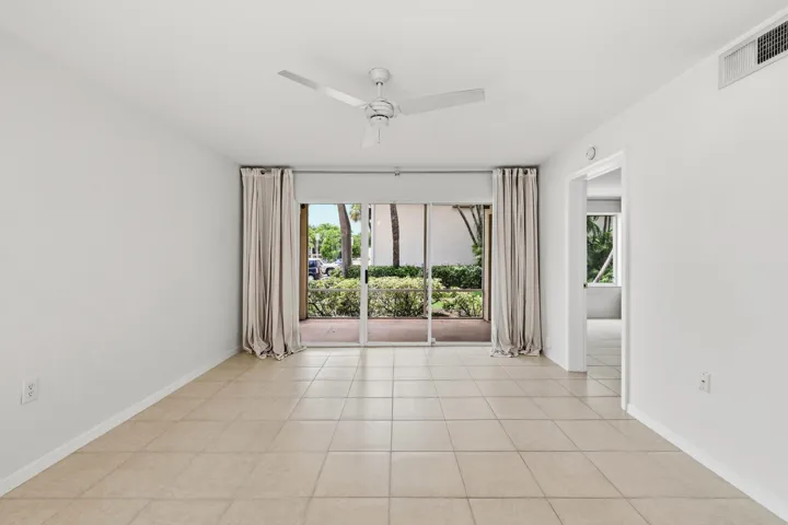 Living area with tile flooring and a ceiling fan