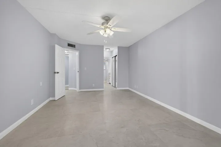 View of master bedroom from balcony area showing bathroom and entry area