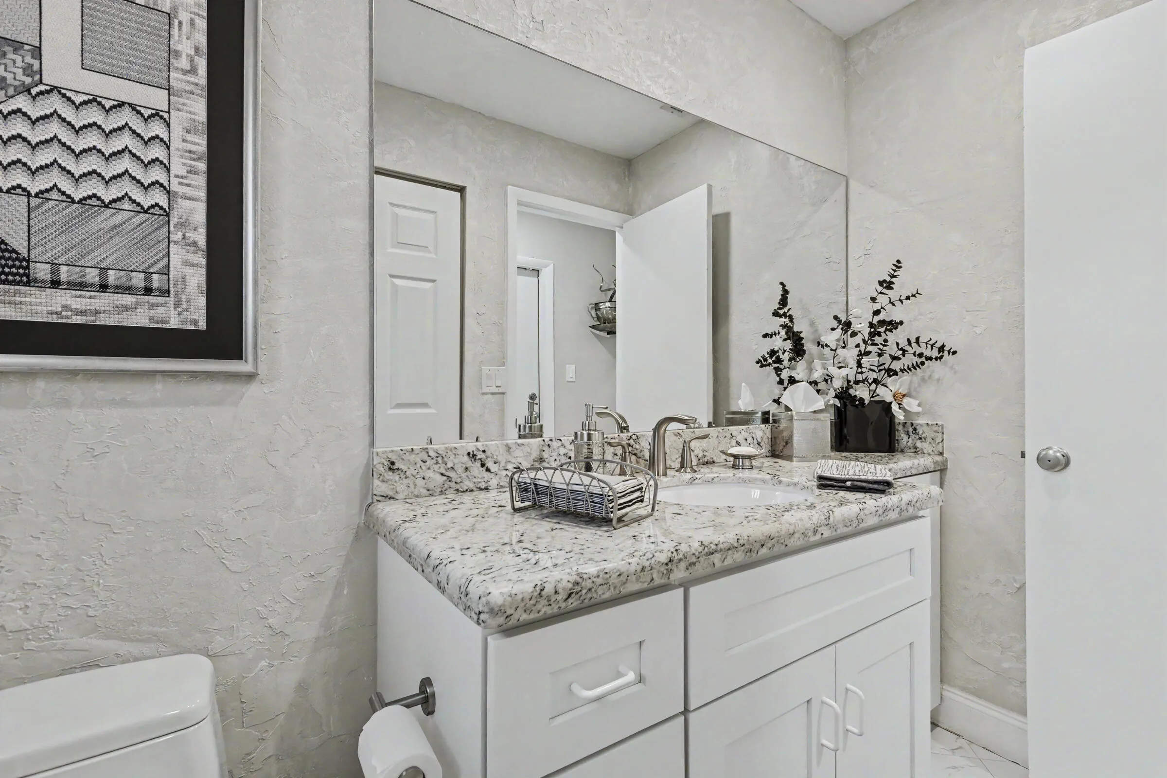 Powder room off living room with laundry clean.