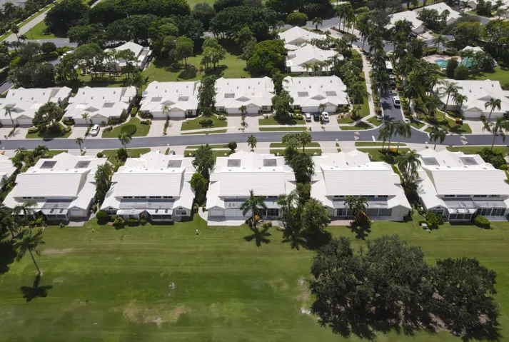 Aerial perspective showcasing a residential community with uniform white rooftops