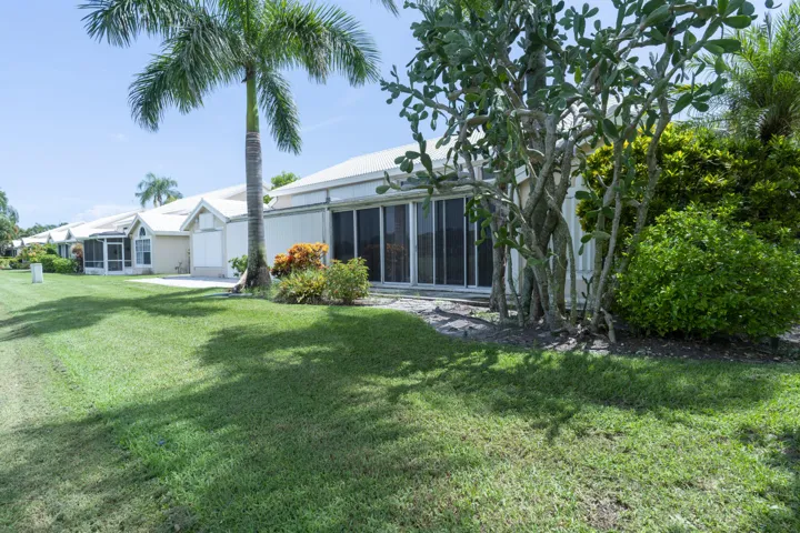 Expansive green space featuring lush landscaping and mature trees