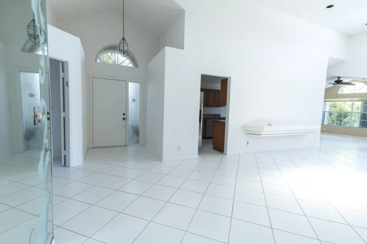Vaulted ceilings, a transom window, and a ceiling fan