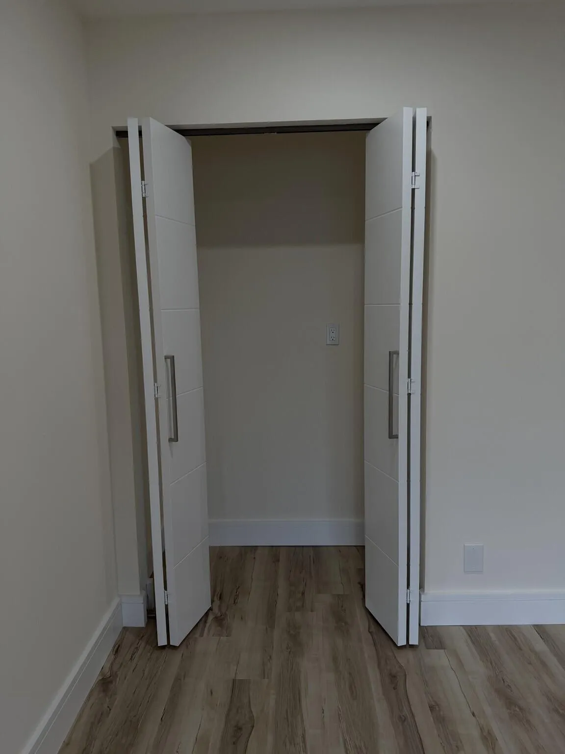 Bifold closet doors featuring horizontal accents and long metallic pulls