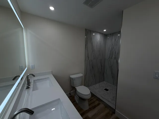 Dual vanity with integrated sinks and brushed nickel faucets