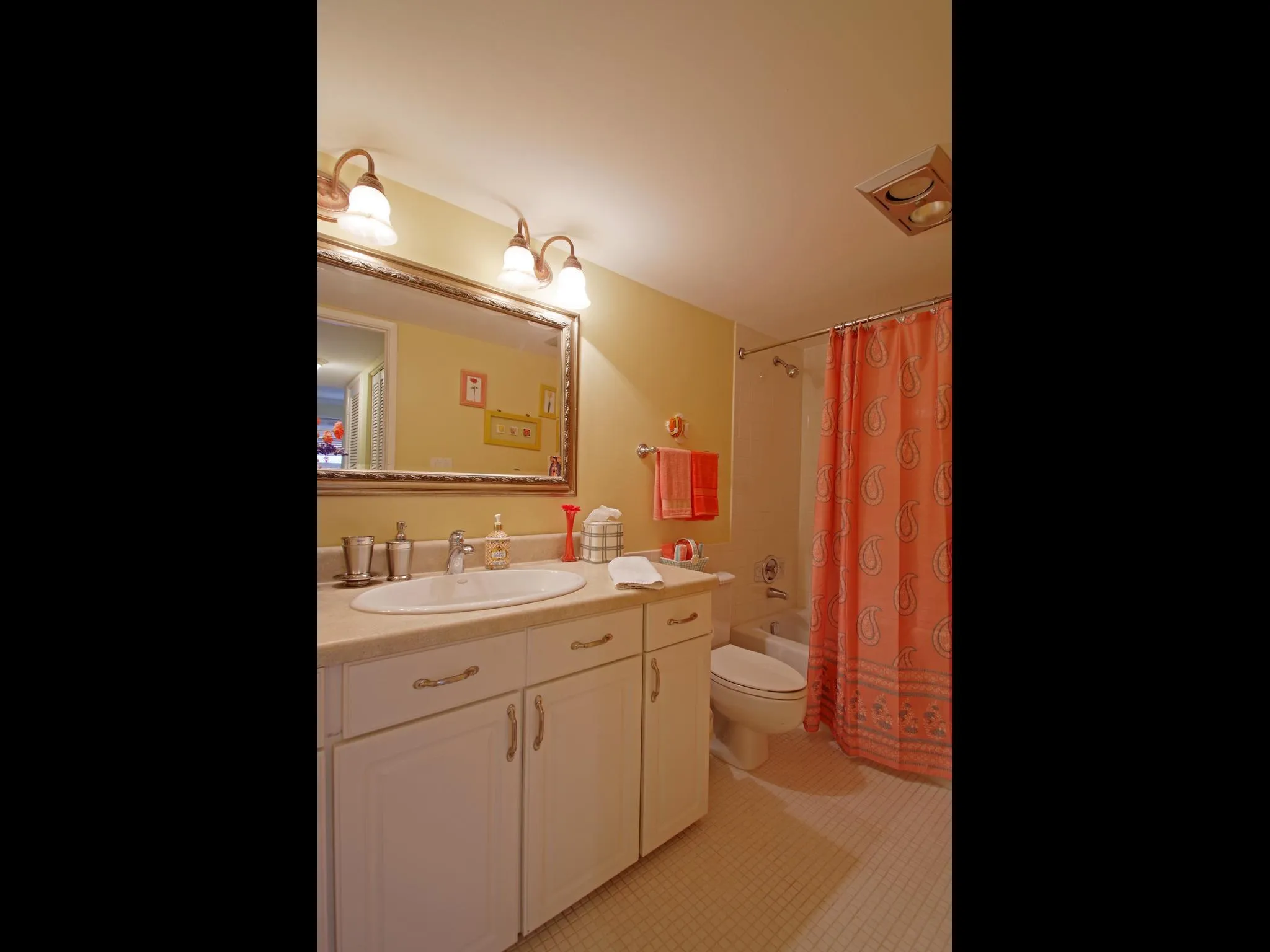 White vanity with cabinet storage, integrated sink, and wall-mounted mirror