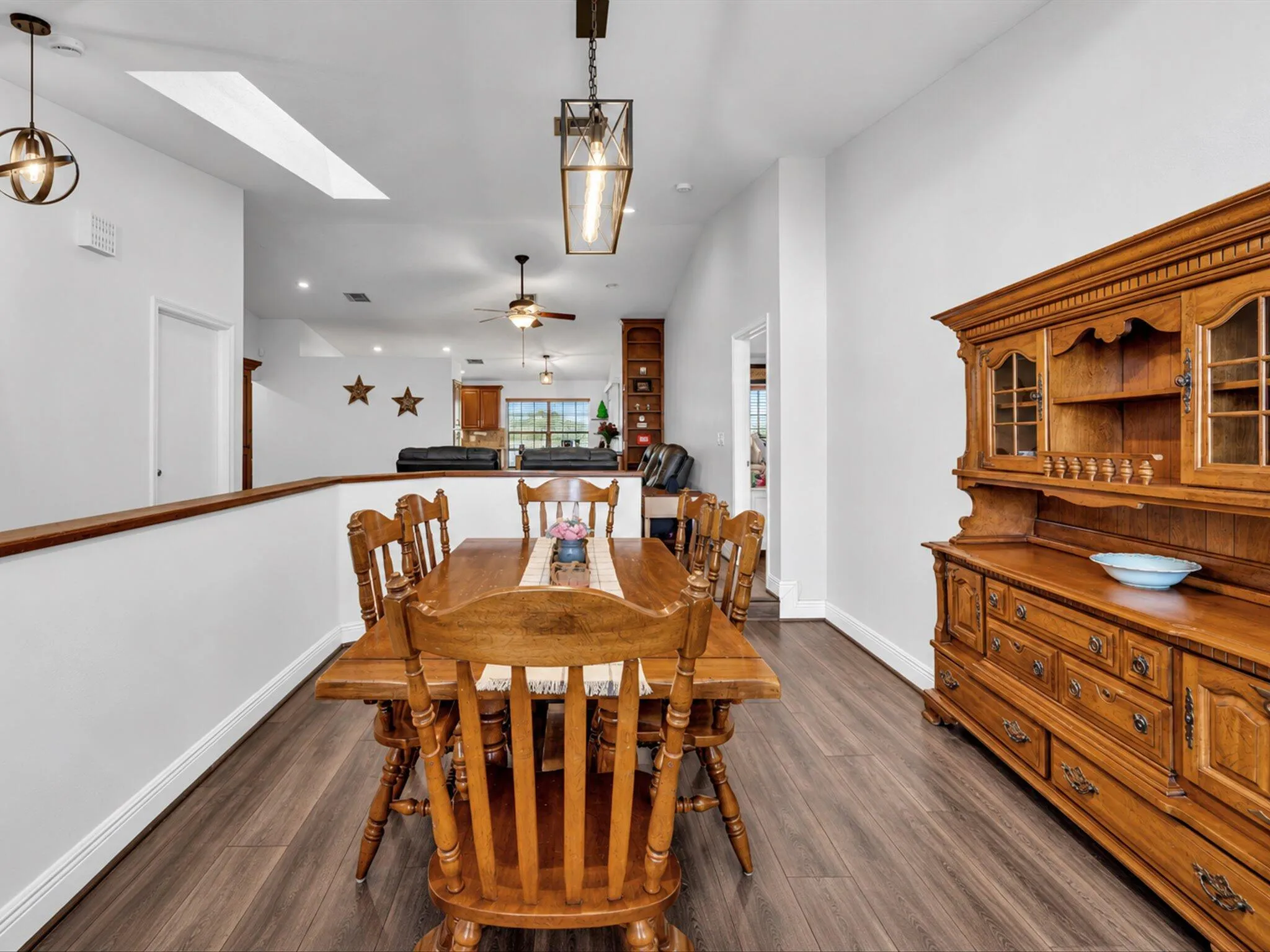 Wood-finish flooring throughout, recessed lighting, and a skylight