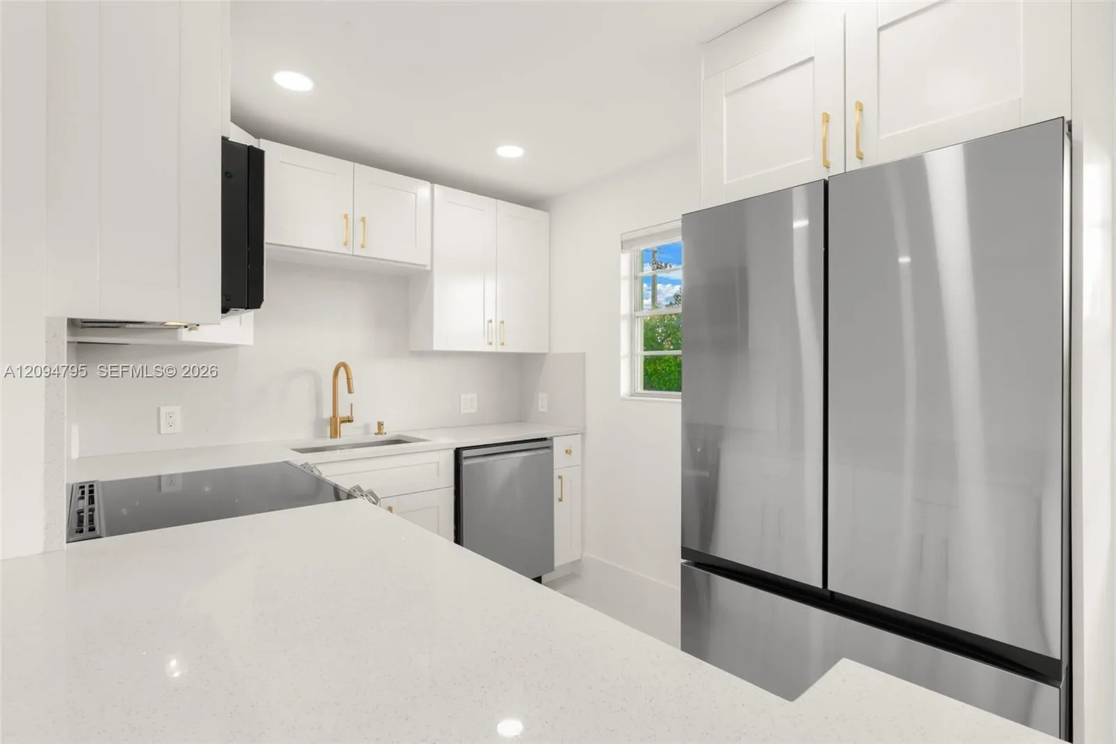 Recessed lighting with smooth finish ceilings. Extra window adds natural lighting.