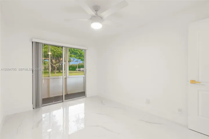 Secondary Bedroom with access to enclosed patio with storage.