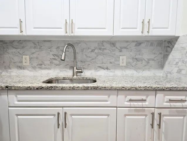 White cabinets with Stone backsplash
