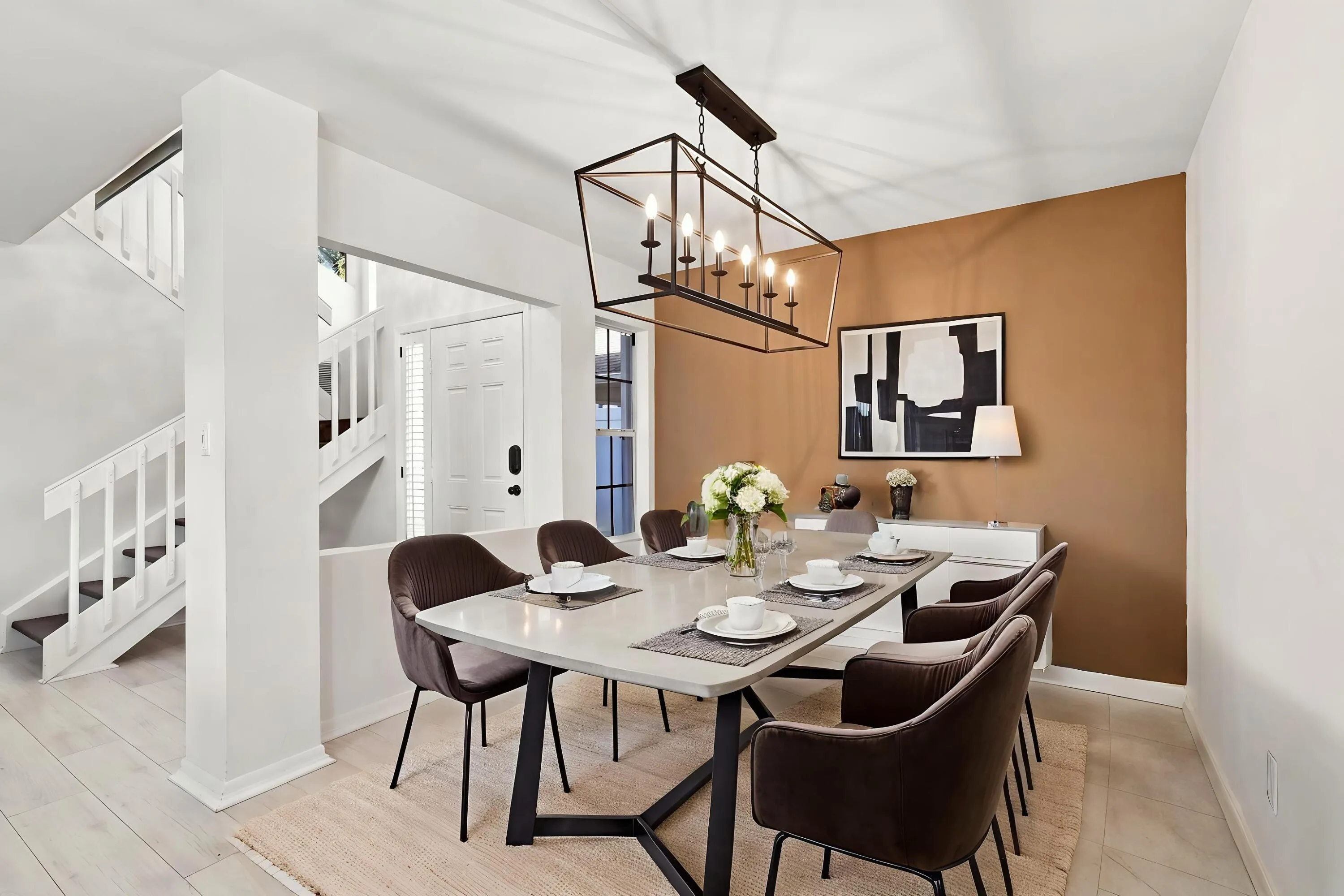 The open-concept floor plan seamlessly connects the living room and elegant formal dining area, creating an inviting setting for memorable dinners and effortless entertaining just steps from the kitchen.