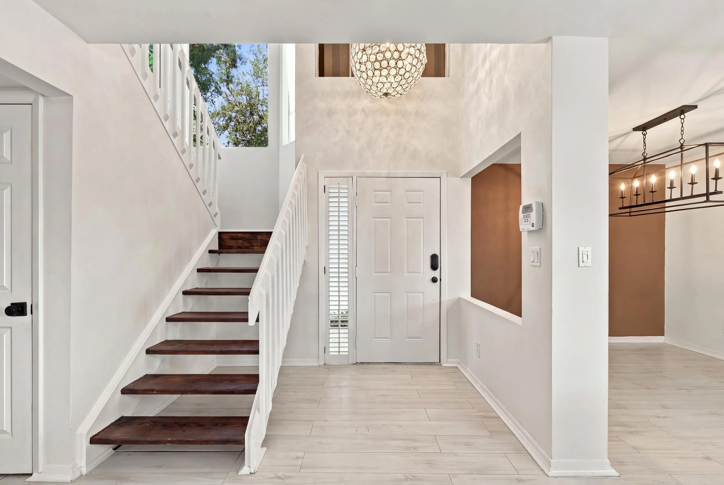 From the moment you enter, soaring ceilings and expansive windows fill the home with natural light, creating a bright, welcoming atmosphere that immediately feels like home.