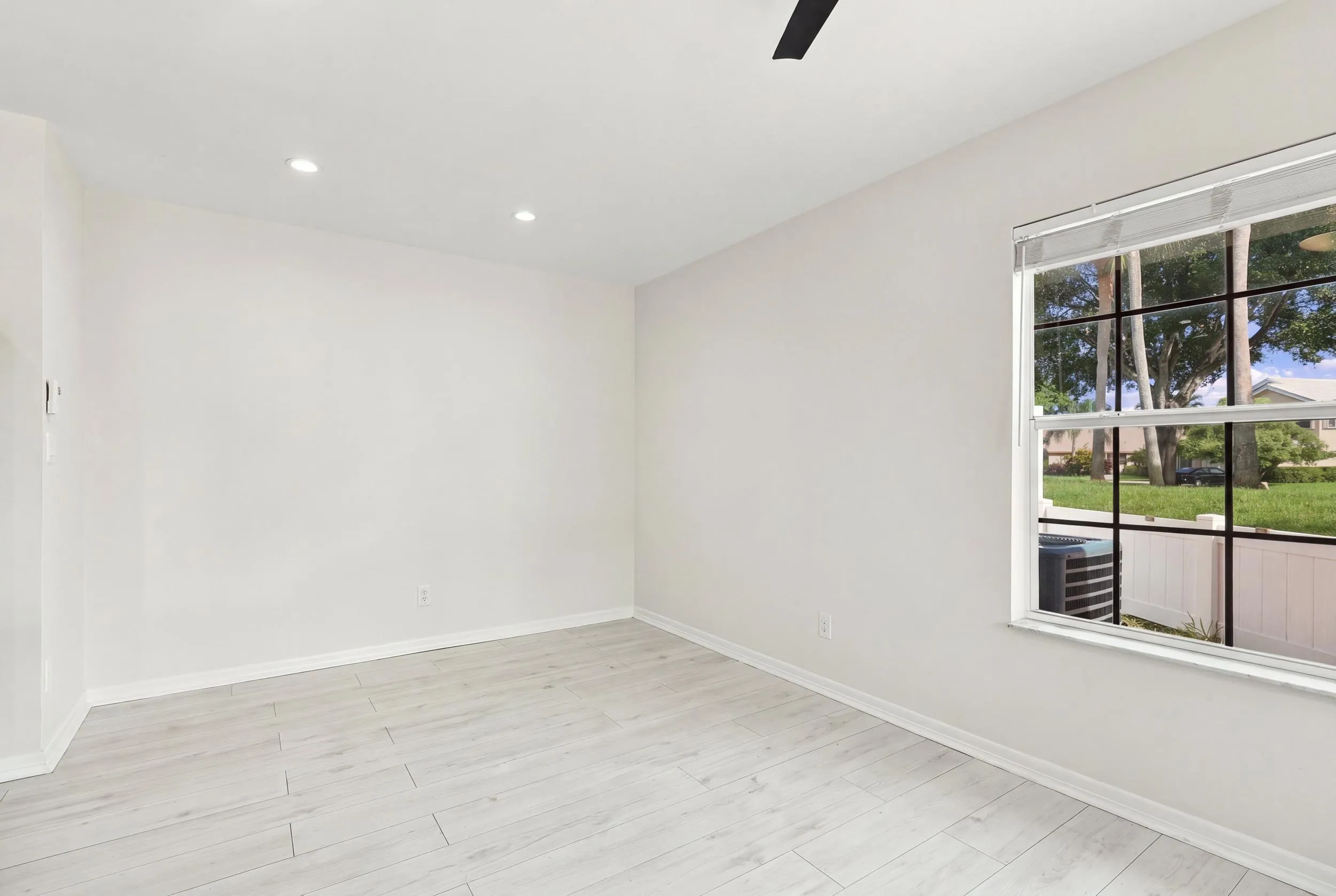 The charming eat-in dining area provides a relaxed and convenient setting for casual meals, surrounded by natural light with sliding glass doors opening to the private patio.