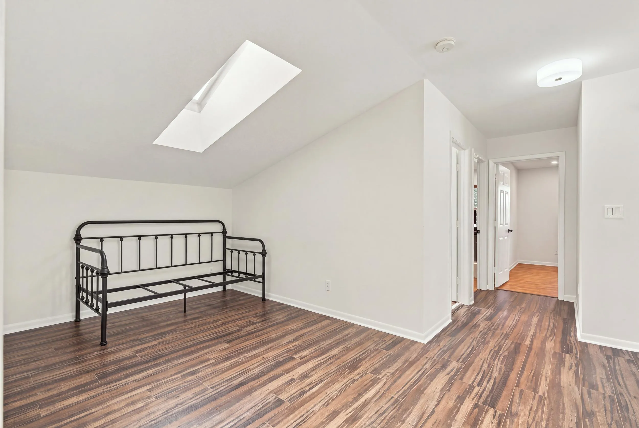 The upstairs loft offers valuable flexibility as a children’s playroom, private home office, or intimate lounge. A skylight fills the space with natural light, creating a bright and inviting retreat separate from the main living areas.