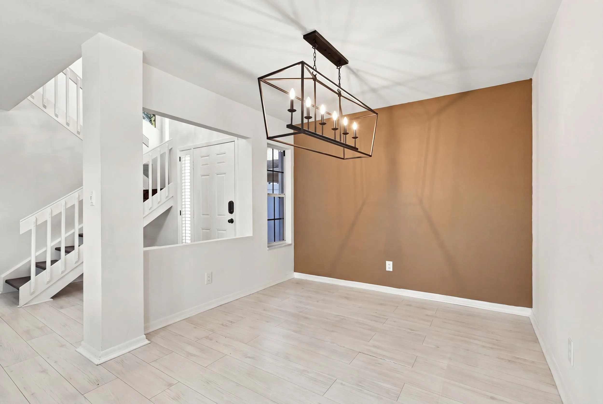 The open-concept floor plan seamlessly connects the living room and elegant formal dining area, creating an inviting setting for memorable dinners and effortless entertaining just steps from the kitchen.