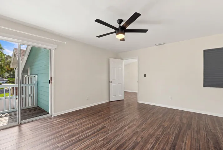 The elegant primary suite offers a private retreat with a beautifully updated bathroom, spacious walk-in closets, and a private balcony overlooking the backyard. It is the perfect place to enjoy your morning coffee while taking in the peaceful setting and mature trees surrounding the community.
