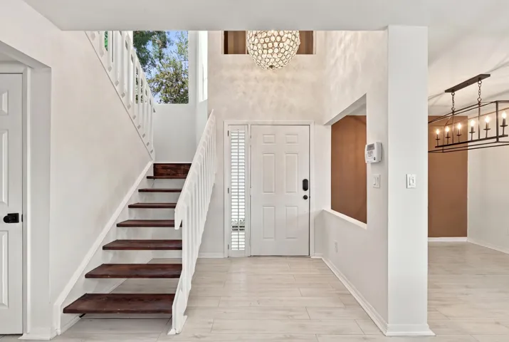 From the moment you enter, soaring ceilings and expansive windows fill the home with natural light, creating a bright, welcoming atmosphere that immediately feels like home.