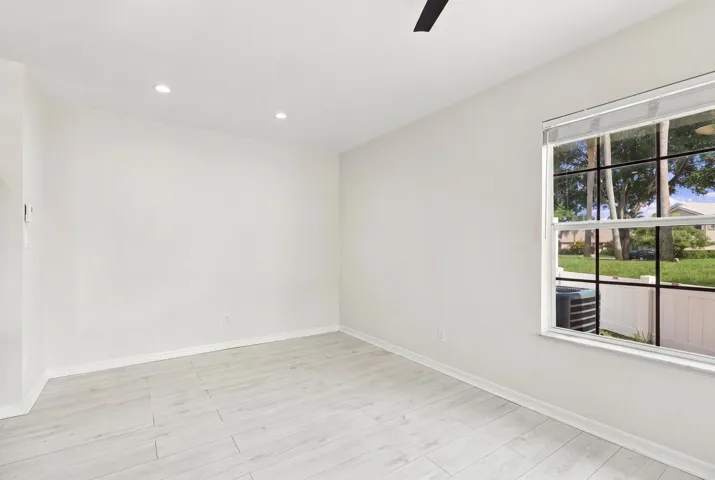 The charming eat-in dining area provides a relaxed and convenient setting for casual meals, surrounded by natural light with sliding glass doors opening to the private patio.