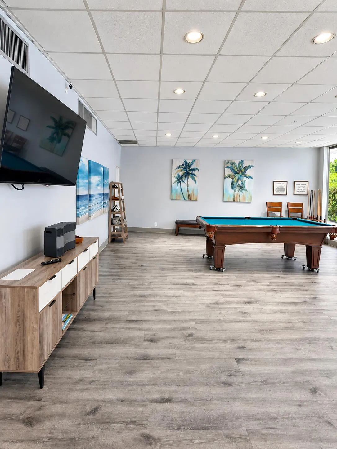 Recreation room with pool table adjacent to the pool also has bathrooms