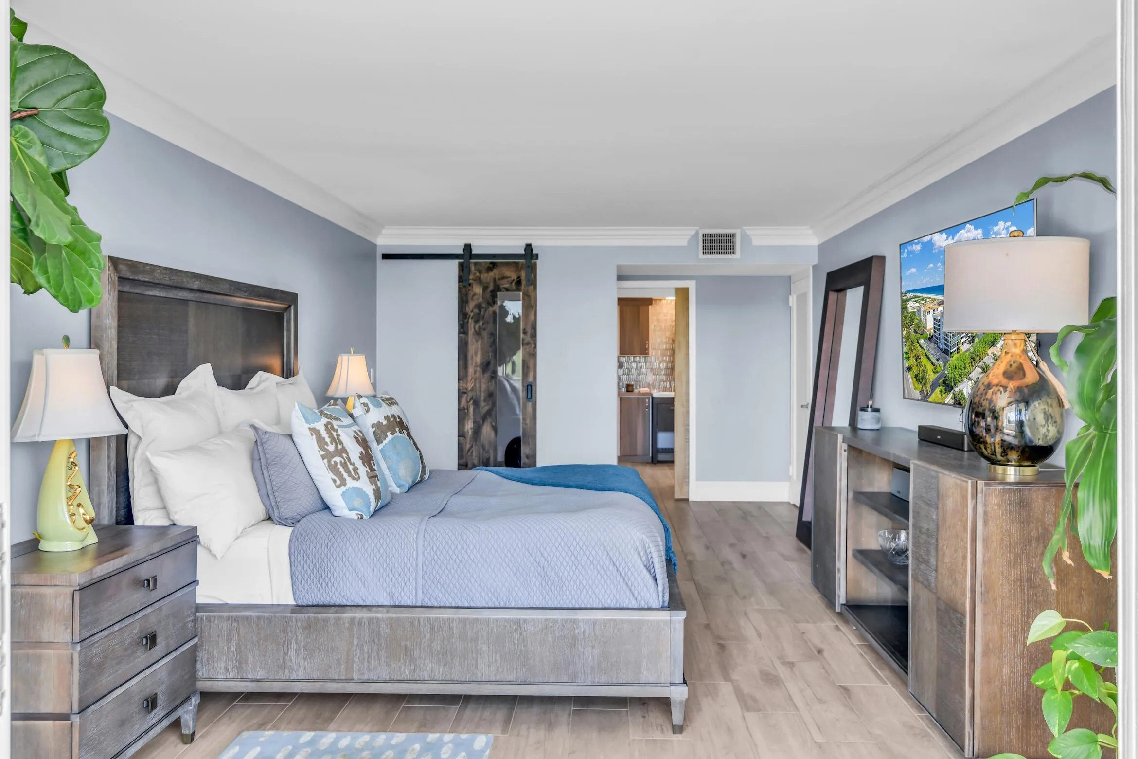 Spacious primary bedroom has abundant natural light