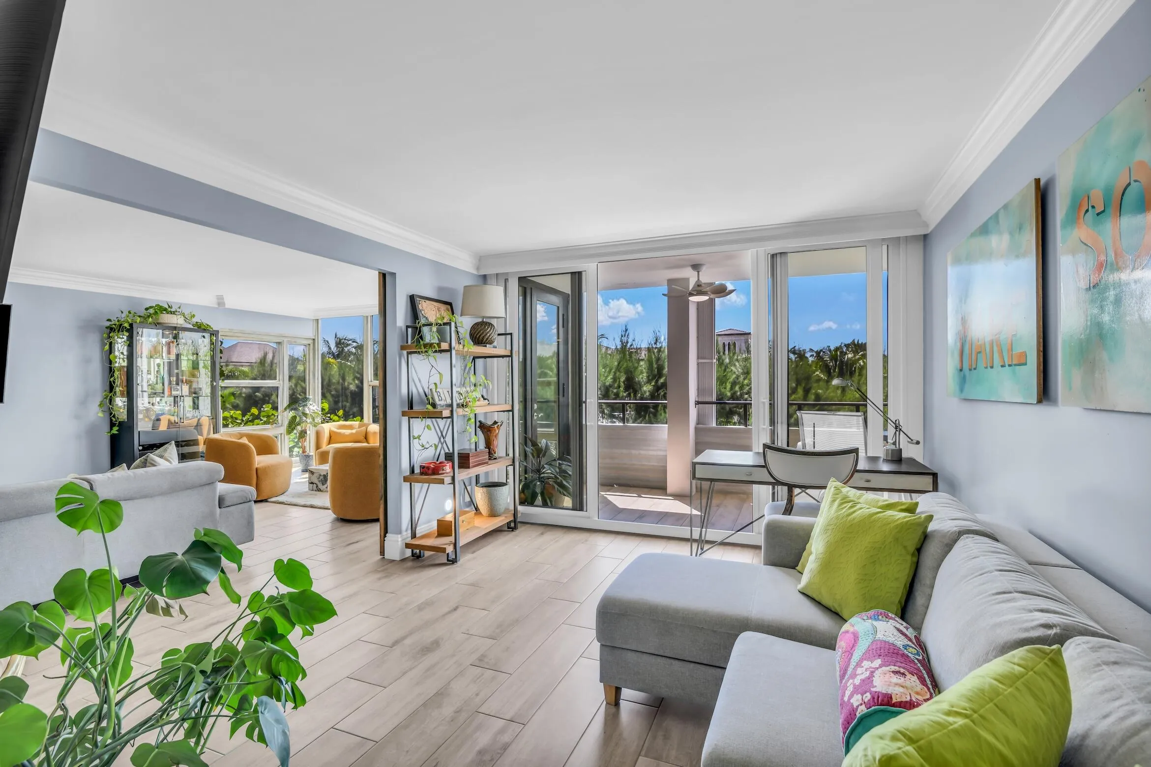 Glass doors open to the balcony and have a hidden motorized blackout shade