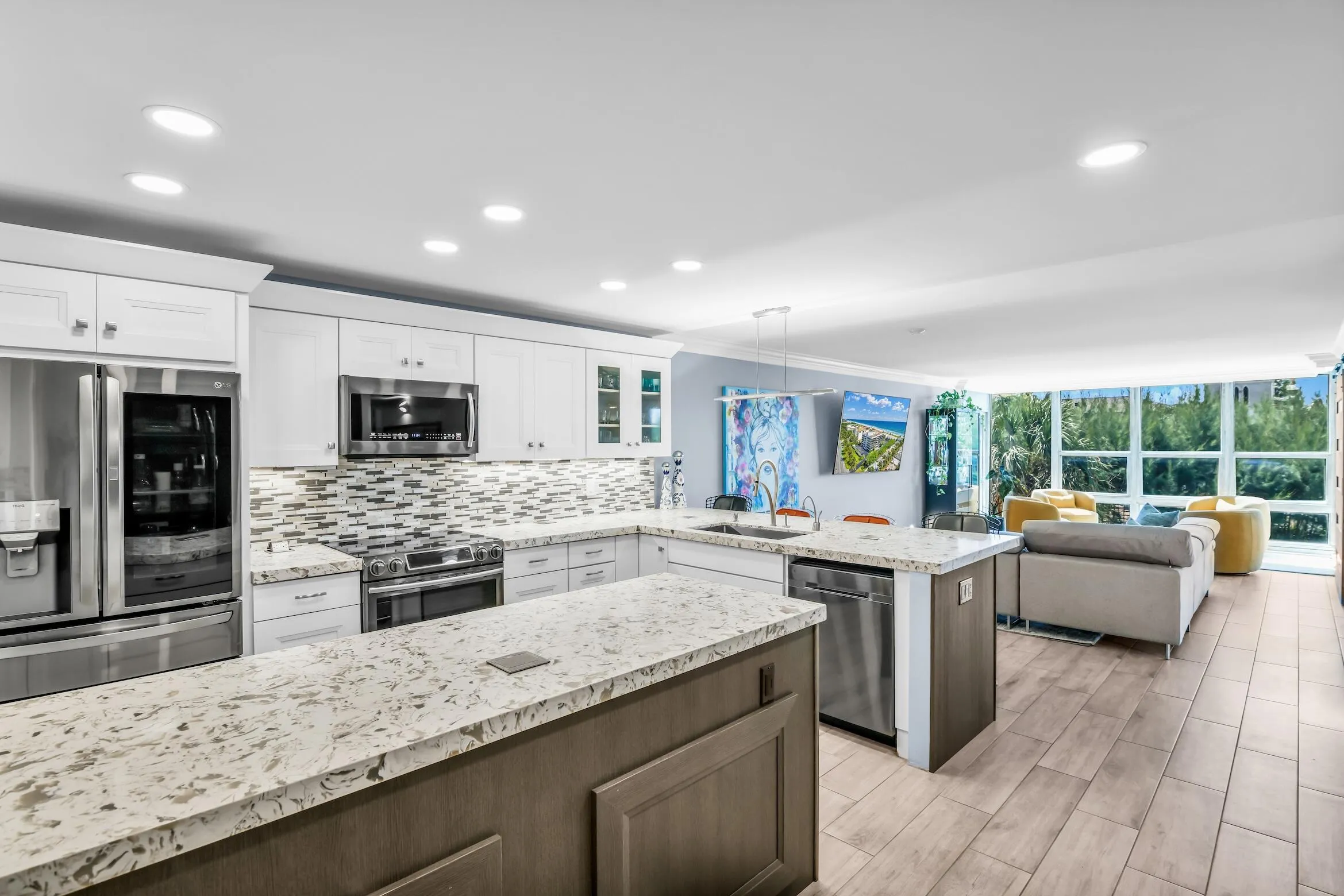 Large kitchen is a chef's delight with abundant storage including a pantry and costum wood cabinetry with roll out drawers and a beverage/wine fridge