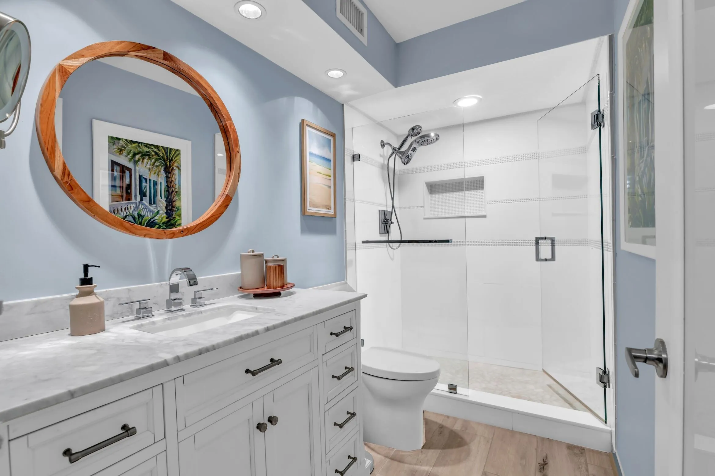 Guest bathroom with marble top and two adjustable shower heads with niche and detailed decorative tile finishes