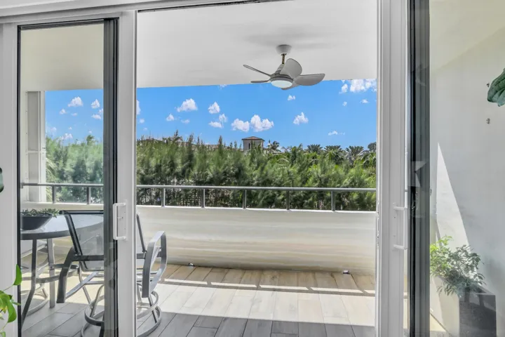 Floor to ceiling impact glass doors open to the balcony