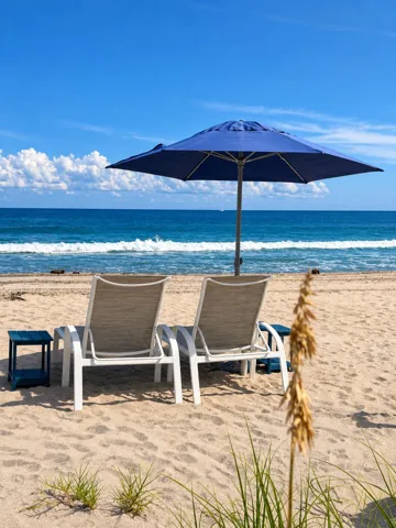 Comfortable beach lounge chairs and umbrellas are available at the beach for Costa Del Rey residents and their guests.