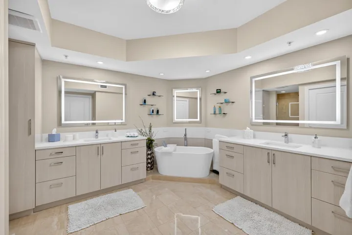 Primary bath offers spa-like retreat, featuring a deep soaking tub, elegant dual vanities provides the perfect setting to unwind.