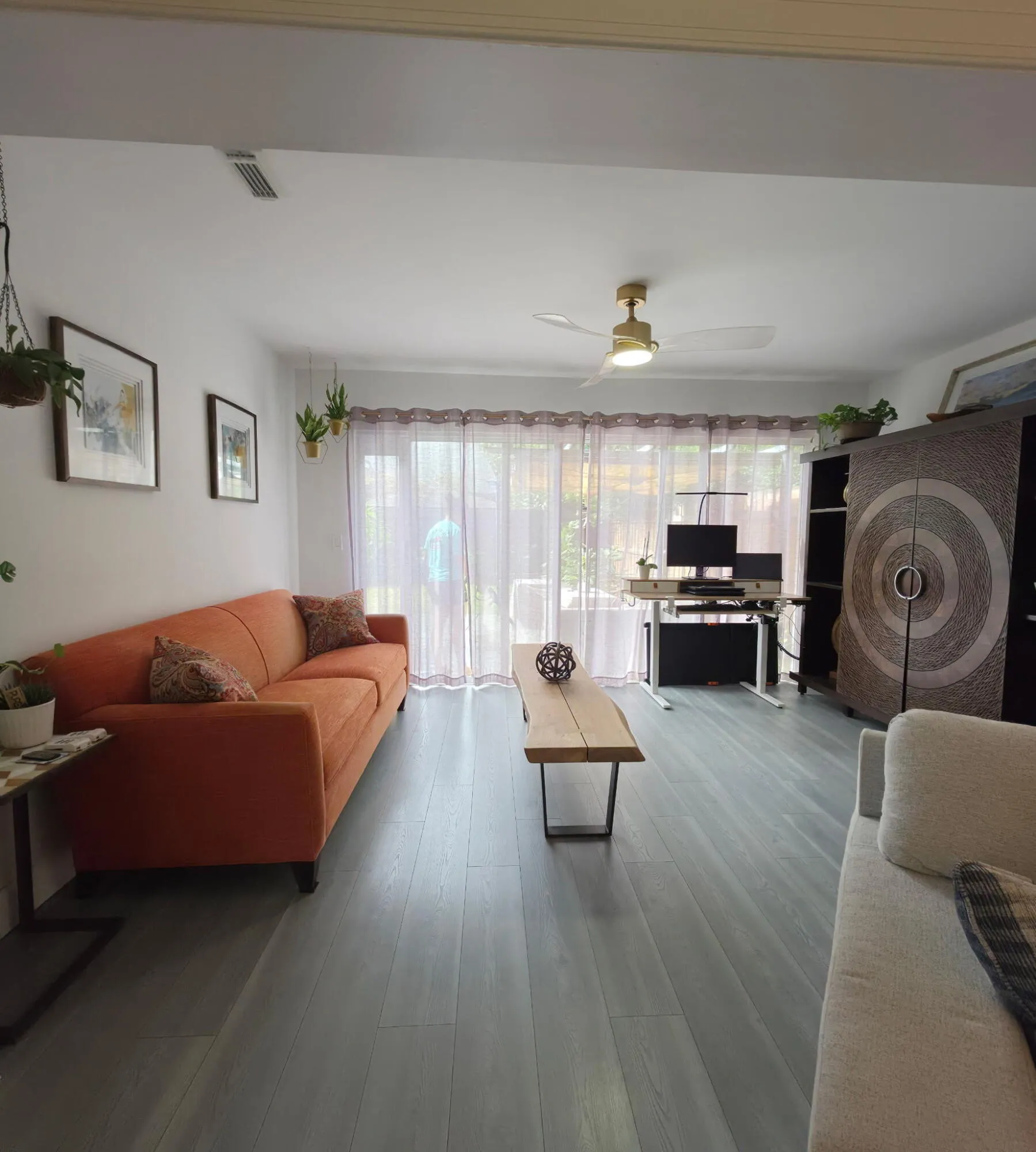 Vaulted ceilings, a gold-finish ceiling fan, recessed lighting, and wood-finish flooring