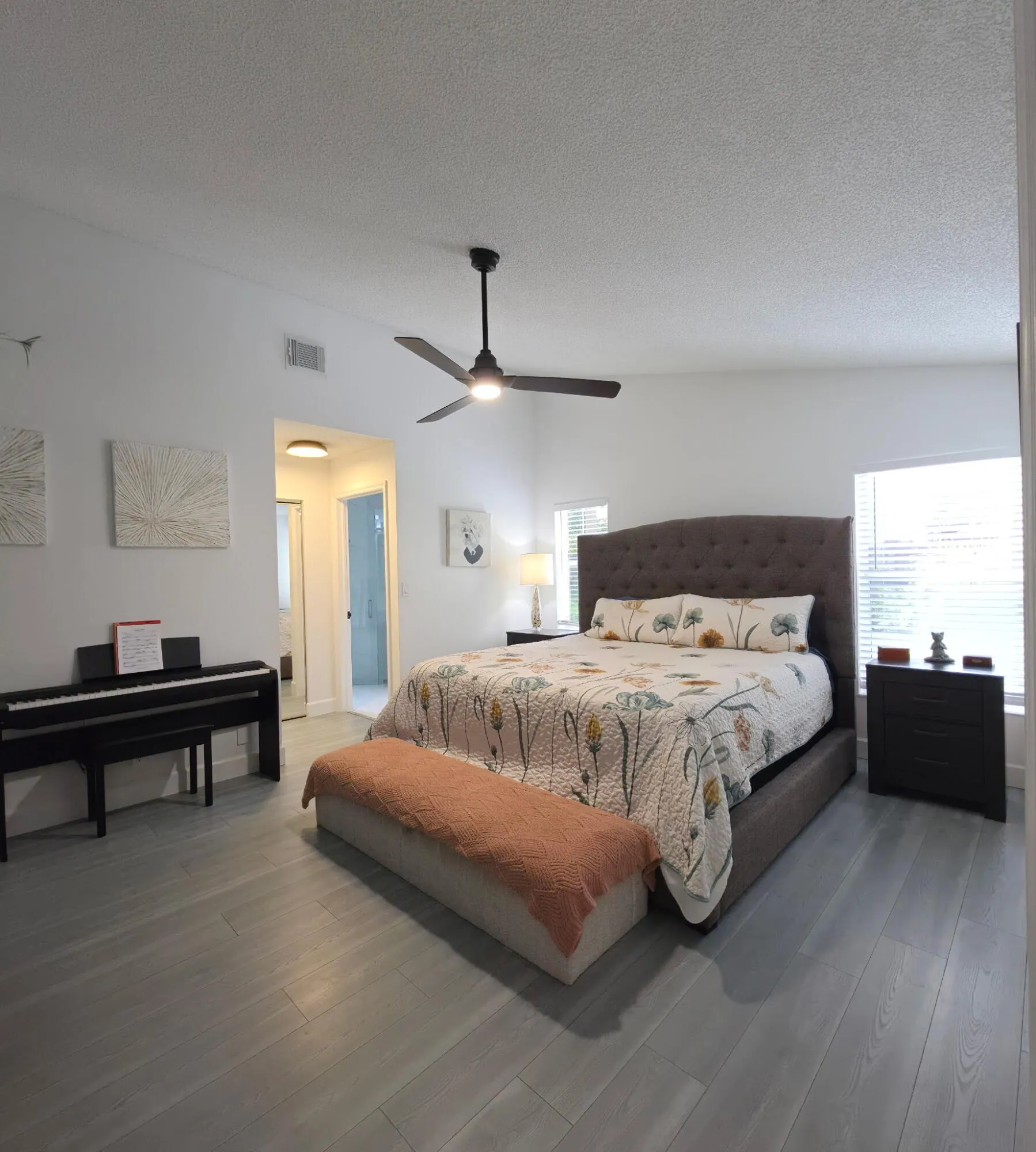 Vaulted ceiling, wood-finish flooring, ceiling fan, and window with blinds