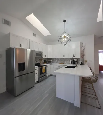 Fully Renovated in 2022 Beautiful backsplash, 2 skylights, black and gold fixtures elevate the space.