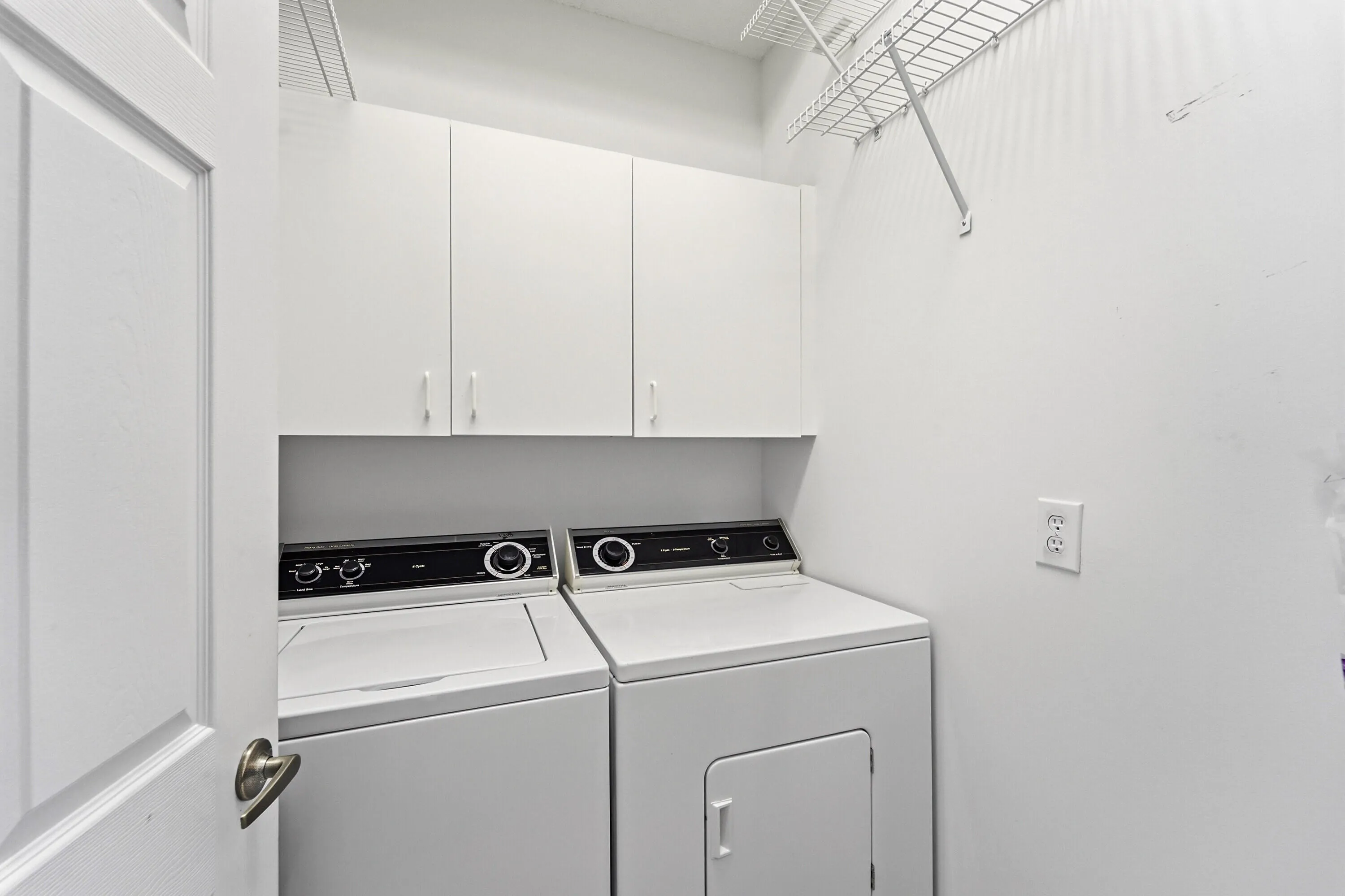 In unit full size washer/dryer separate laundry room with storage