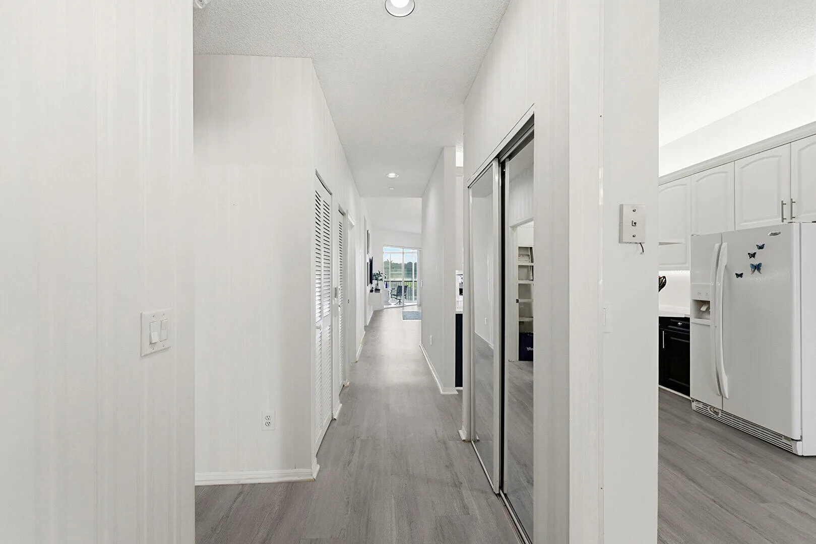 View from front entrance, hallway to main living area. 2 additional closets