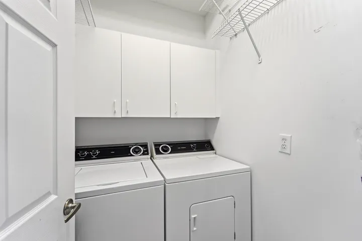 In unit full size washer/dryer separate laundry room with storage