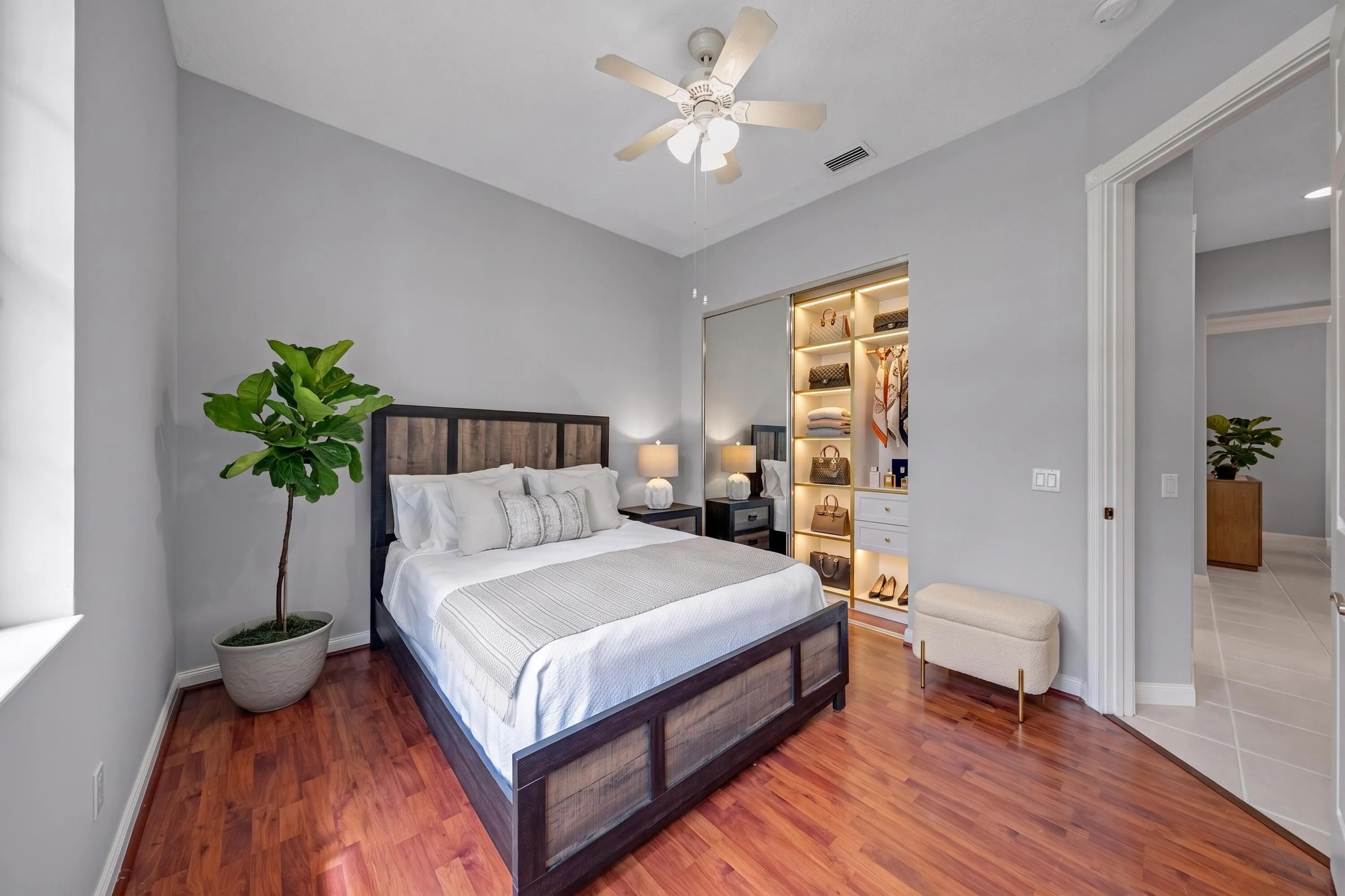 Bedroom with built-in closet shelving, set just off the hallway (closet virtually staged)