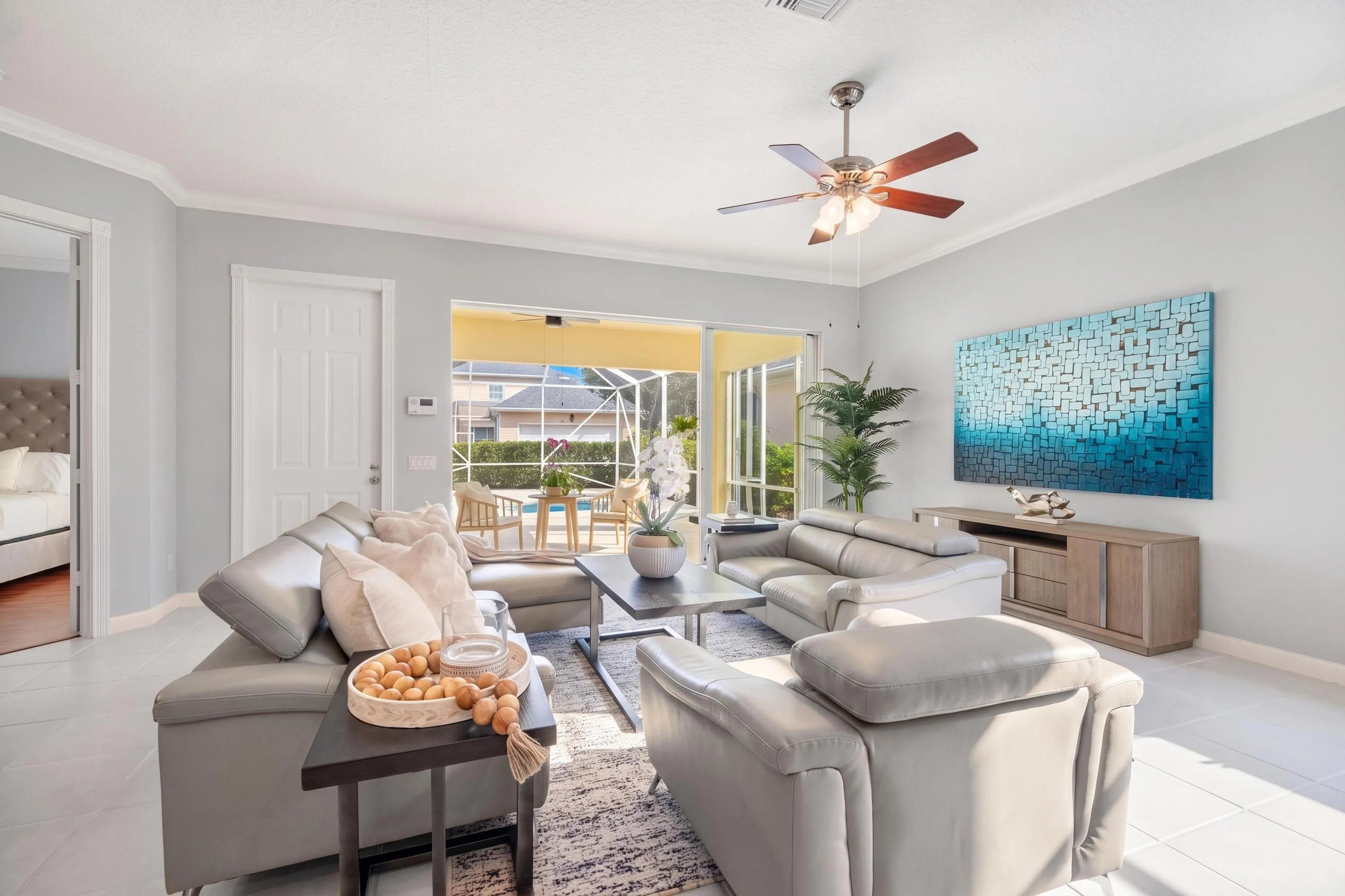 Living room with sliders to the screened patio and direct access to the primary bedroom