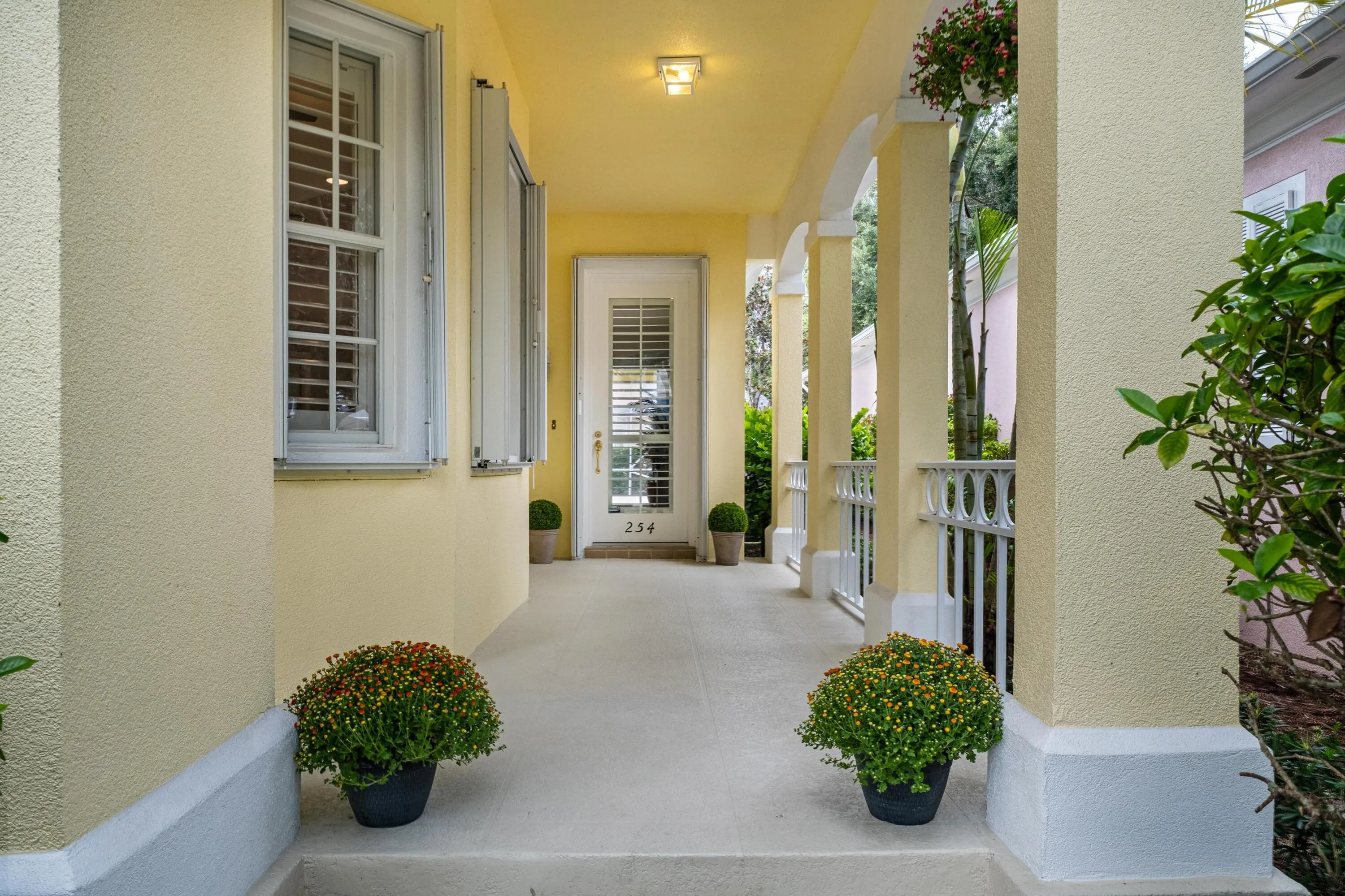 Covered front porch leading to the main entrance door