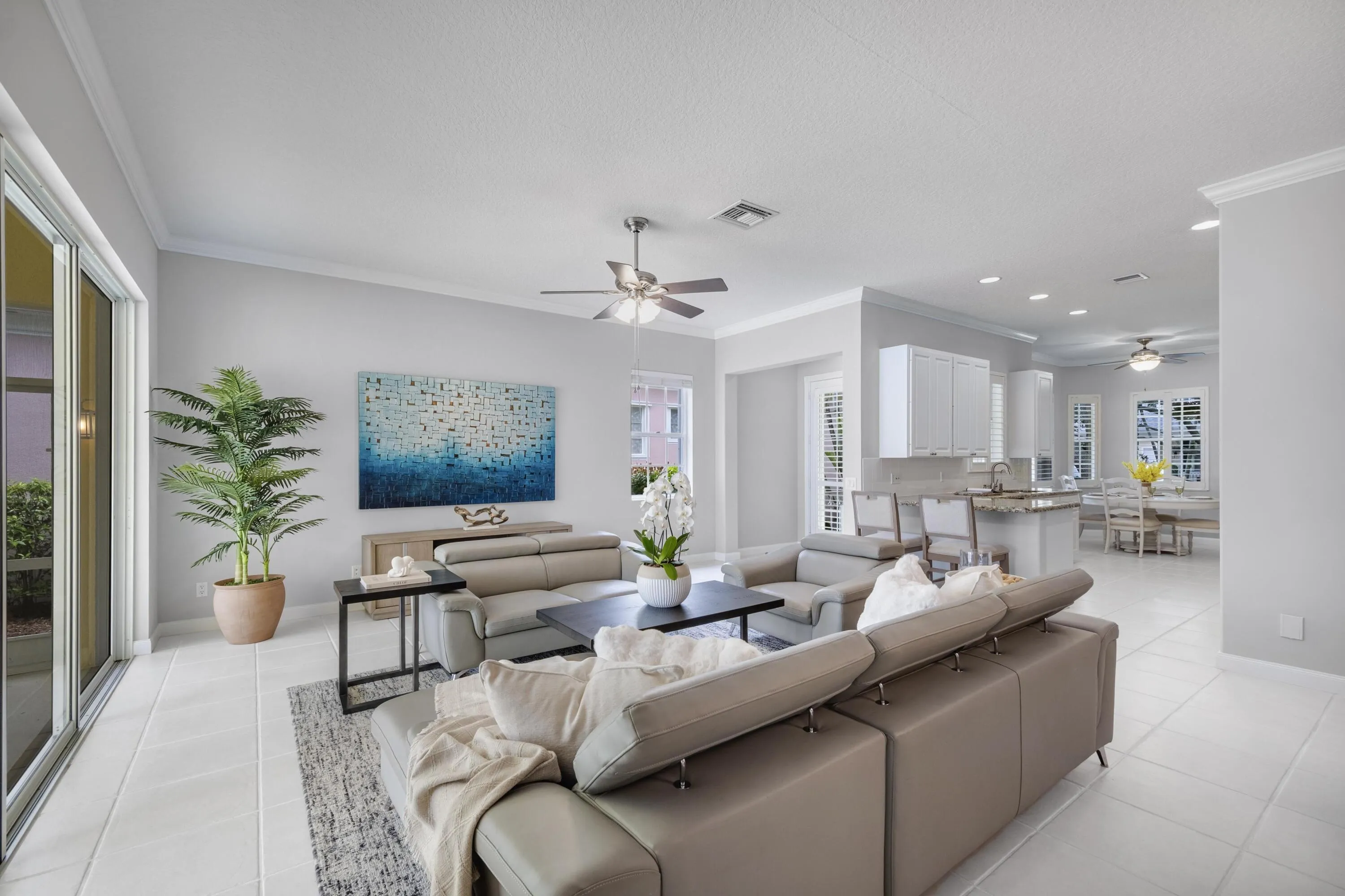 Living room with crown molding and recessed lighting, open to the kitchen, formal dining table, and breakfast nook