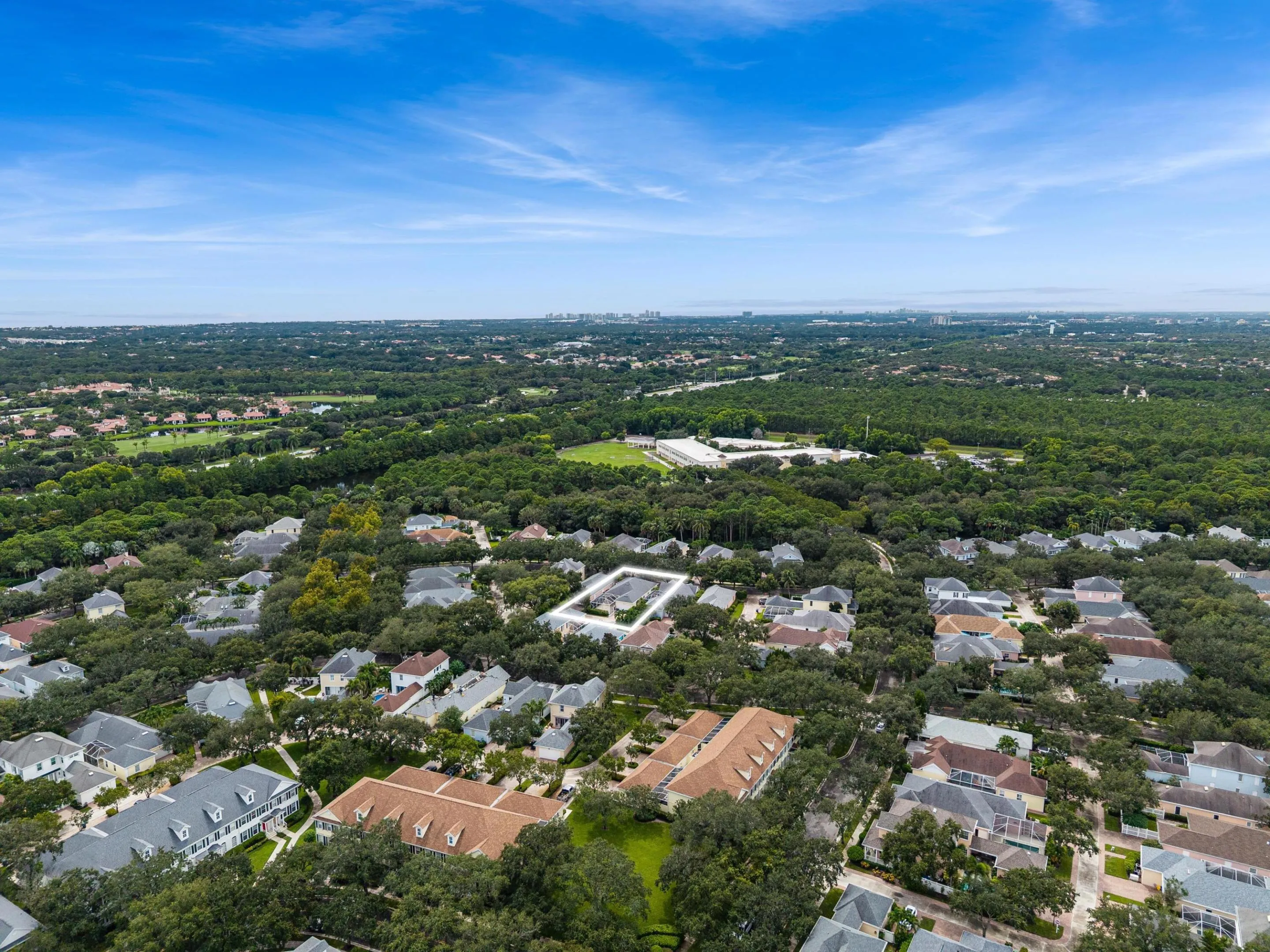 Aerial with the residence outlined within the mature, tree-lined neighborhood