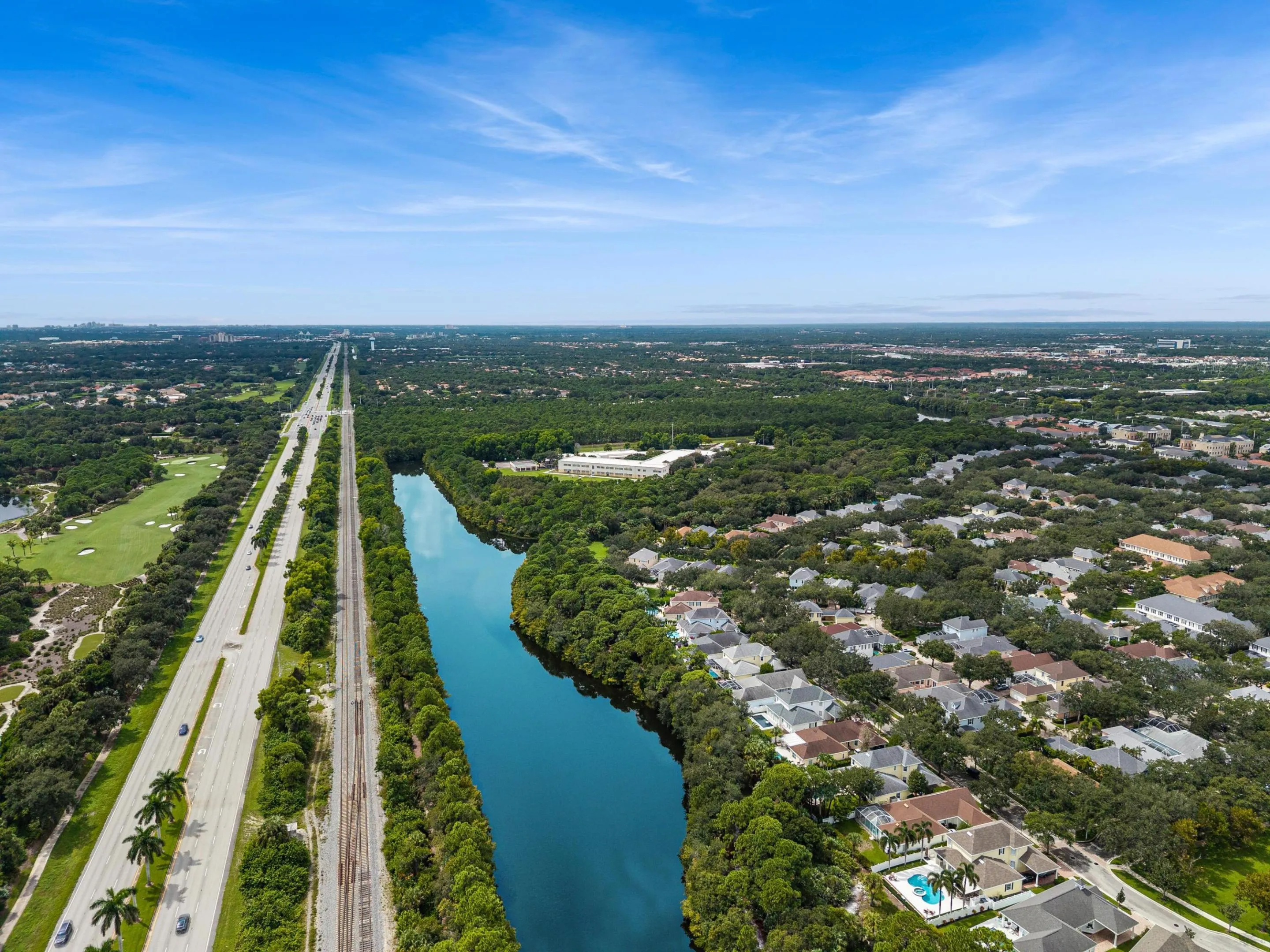 Aerial showing a nearby lake, golf course and preserve land