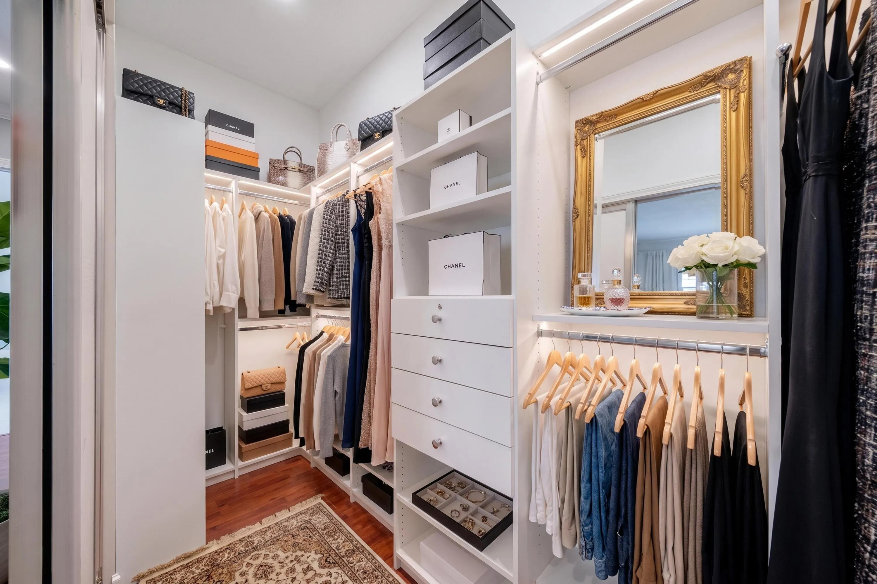 New primary walk-in closet with custom shelving and drawers (closet virtually staged)