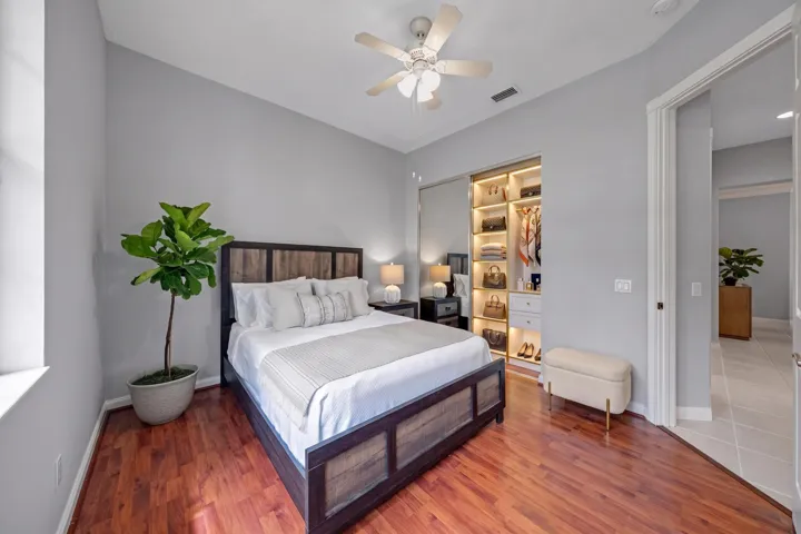 Bedroom with built-in closet shelving, set just off the hallway (closet virtually staged)