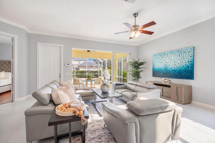 Living room with sliders to the screened patio and direct access to the primary bedroom