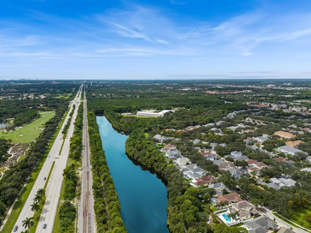Aerial showing a nearby lake, golf course and preserve land
