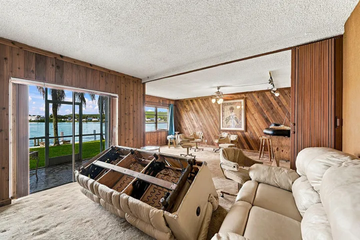 Access To Exterior, Ceiling Fan, Water View, Waterfront, Wood Wall, Textured Ceiling