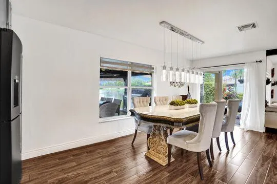 Wood-finish flooring, recessed lighting, and a window with blinds